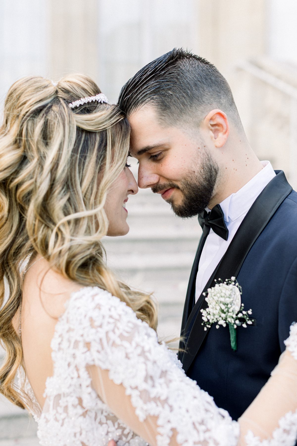 Photographe de mariage Fine Art à Paris — Couple enlacé et amoureux front contre front avec mise en valeur de la boutonnière