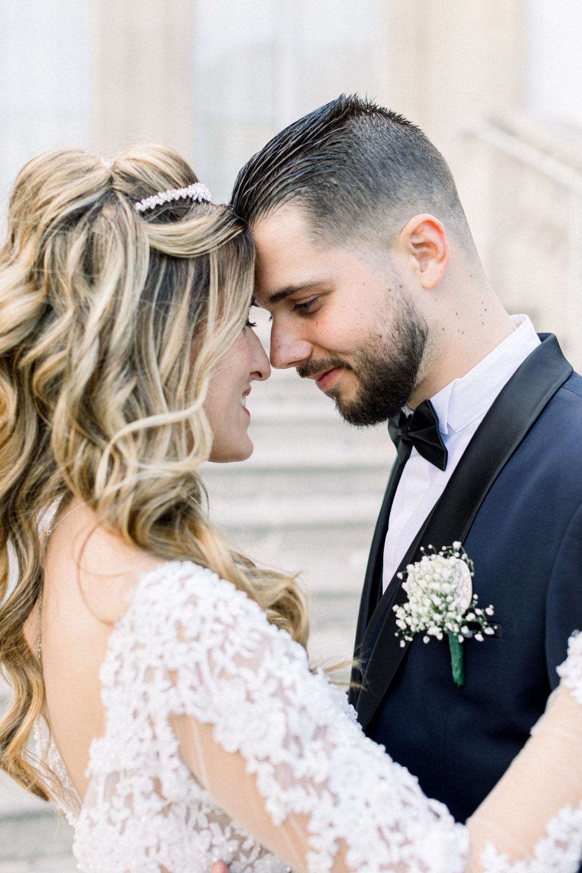 Photographe de mariage Fine Art à Paris — Couple enlacé et amoureux front contre front avec mise en valeur de la boutonnière